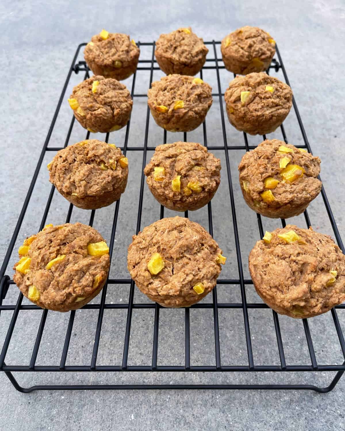 Fiber One mango muffins cooling on wire rack.