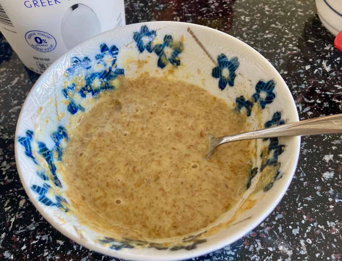 Mixing flaxseed meal, honey and egg in small bowl with fork.