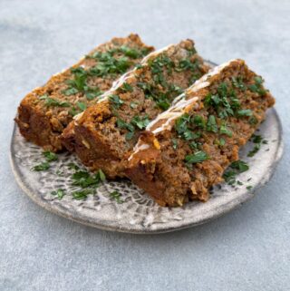 Textured Pottery Plate with 3 slices of meatloaf garnished with parsley