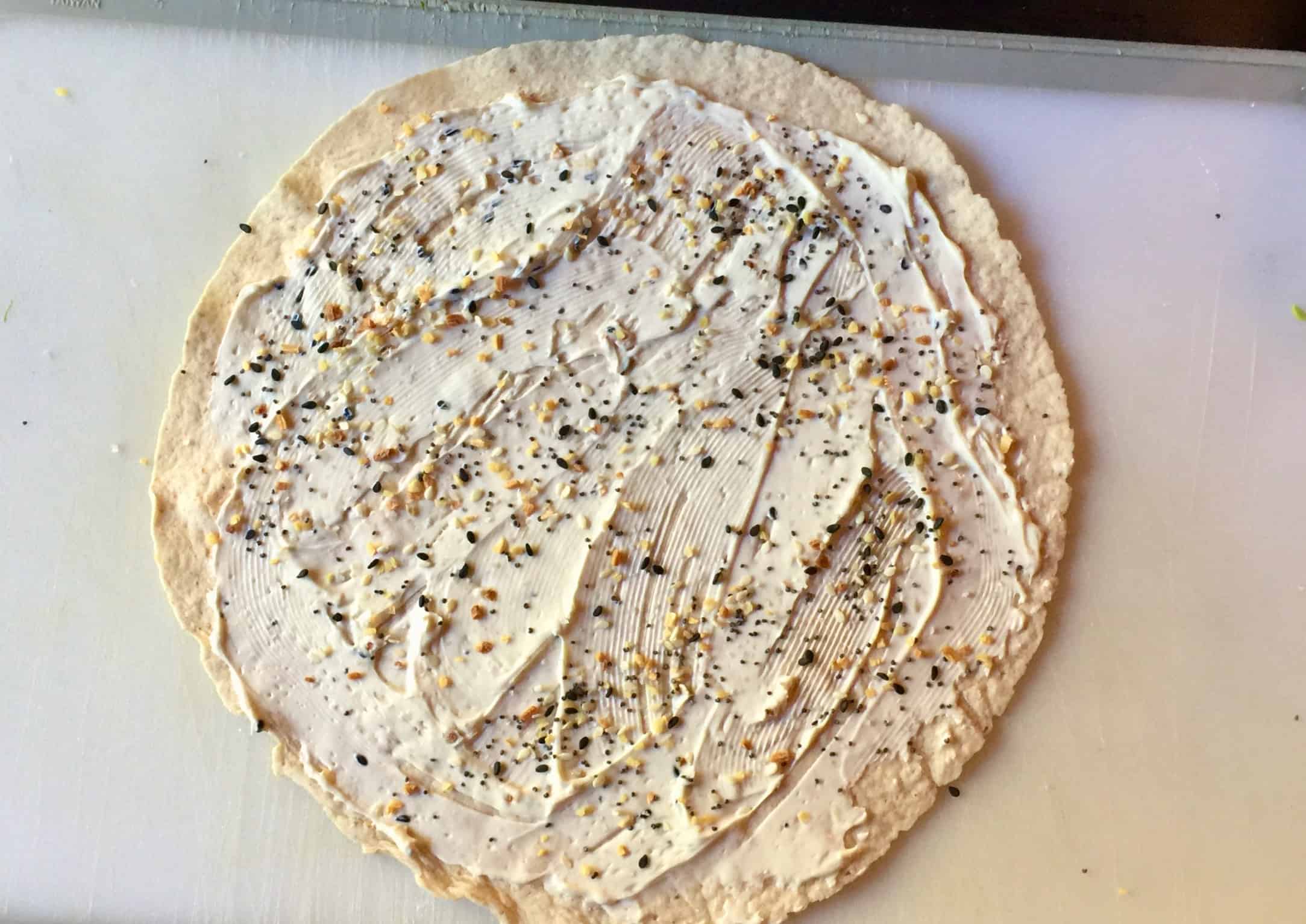 Low carb tortilla with cream cheese spread and everything bagel seasoning.