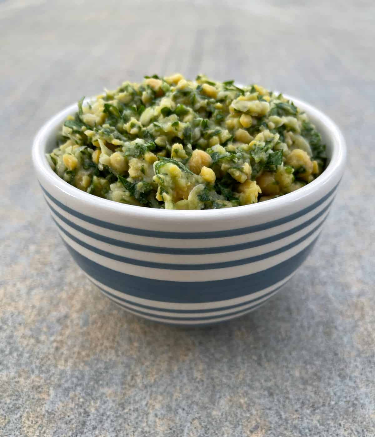 Chickpea tabbouleh in blue striped bowl.