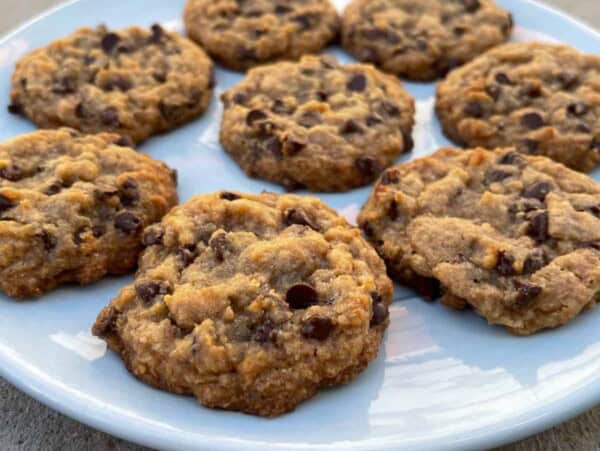 round white plate with tablespoon chocolate chop cookies arranged in a circle