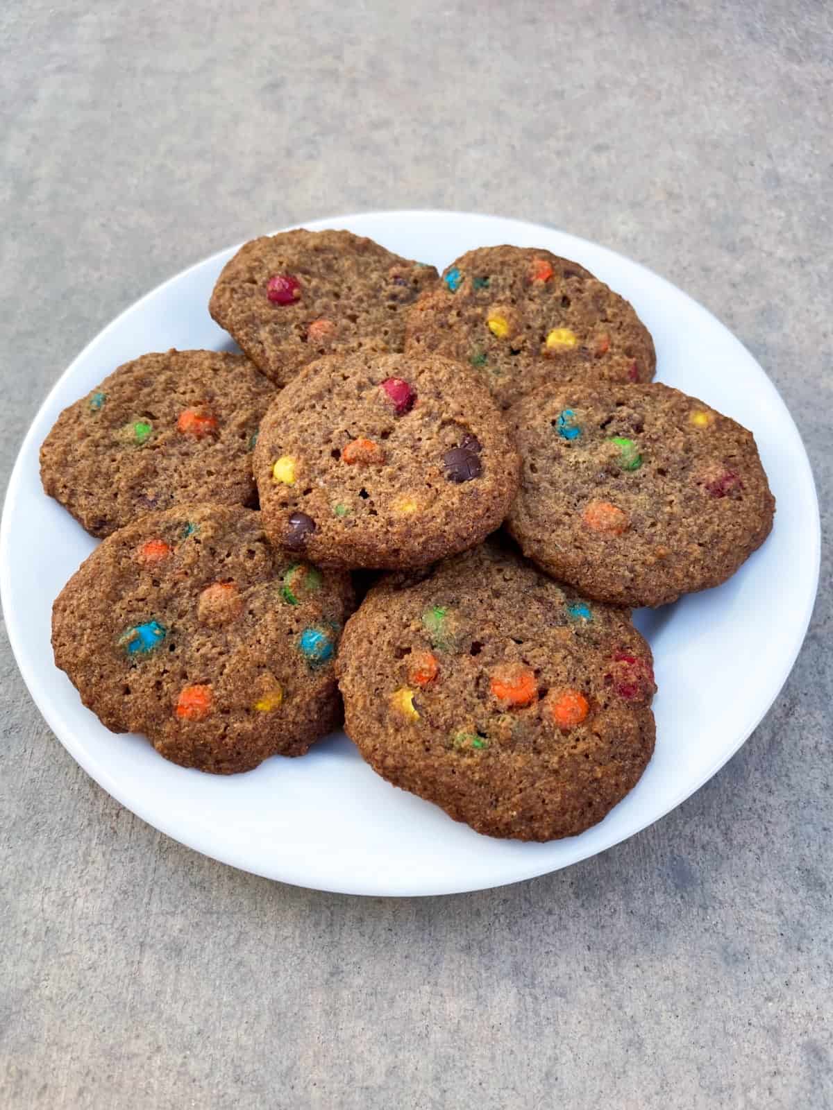 Tablespoon M and M Cookies on white plate.