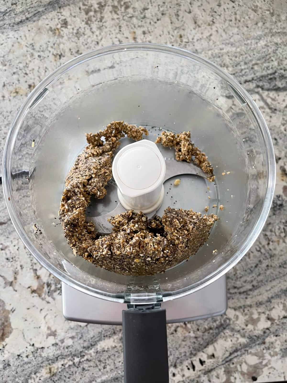 Walnuts, dates, oats and chia seeds in food processor.