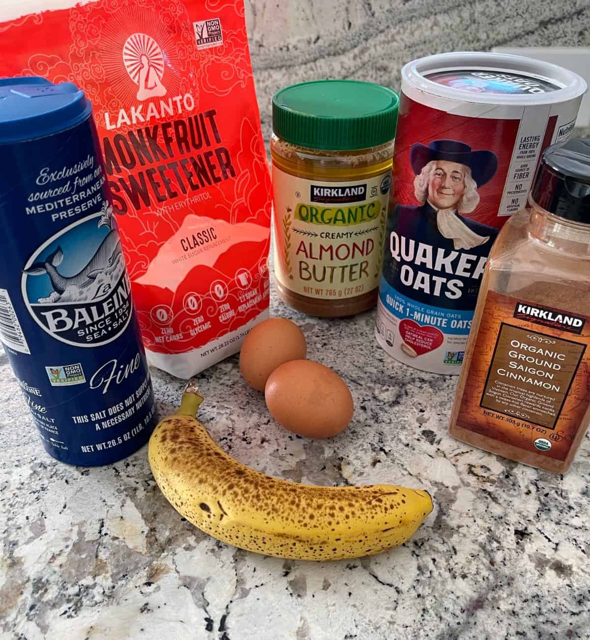 Ingredients including overripe banana, eggs, almond butter, rolled oats, cinnamon, salt and monk fruit sweetener.