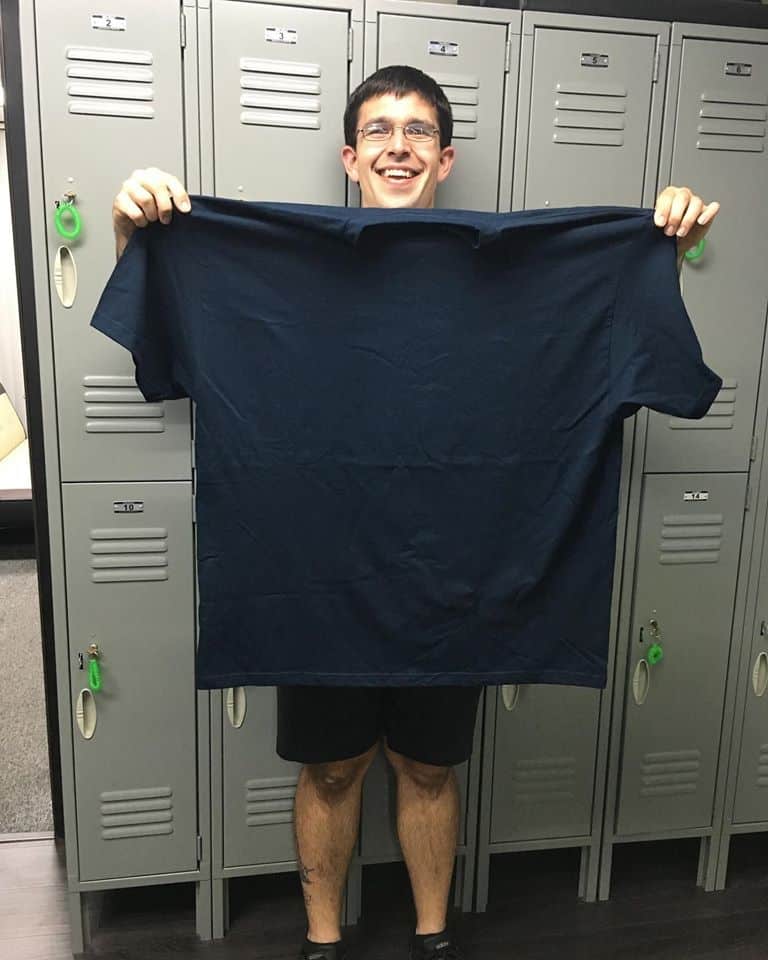 Dylan holding large t-shirt he wore before losing weight.