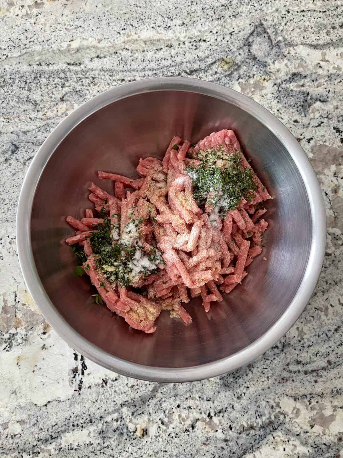 Ground pork, garlic powder, sea salt, sage and thyme in mixing bowl.