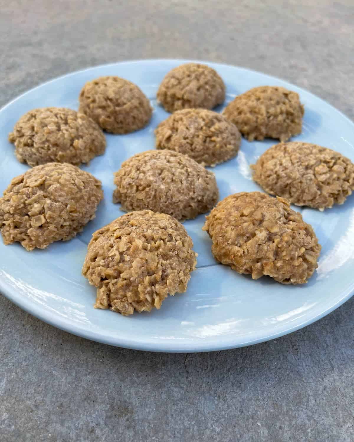 Peanut butter oat no-bake cookies on small blue plate.