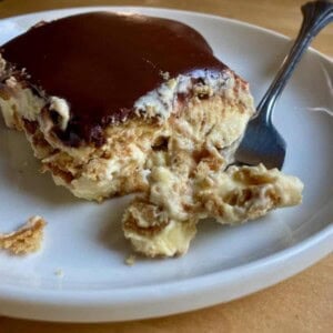 easy icebox eclair dessert on white plate with fork from front