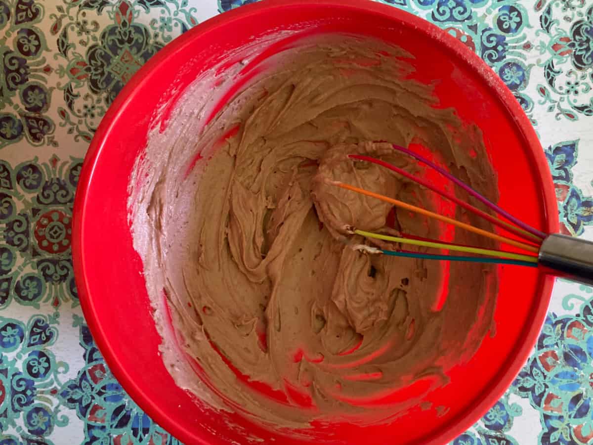 Whisking yogurt and sugar-free chocolate Jello in mixing bowl.