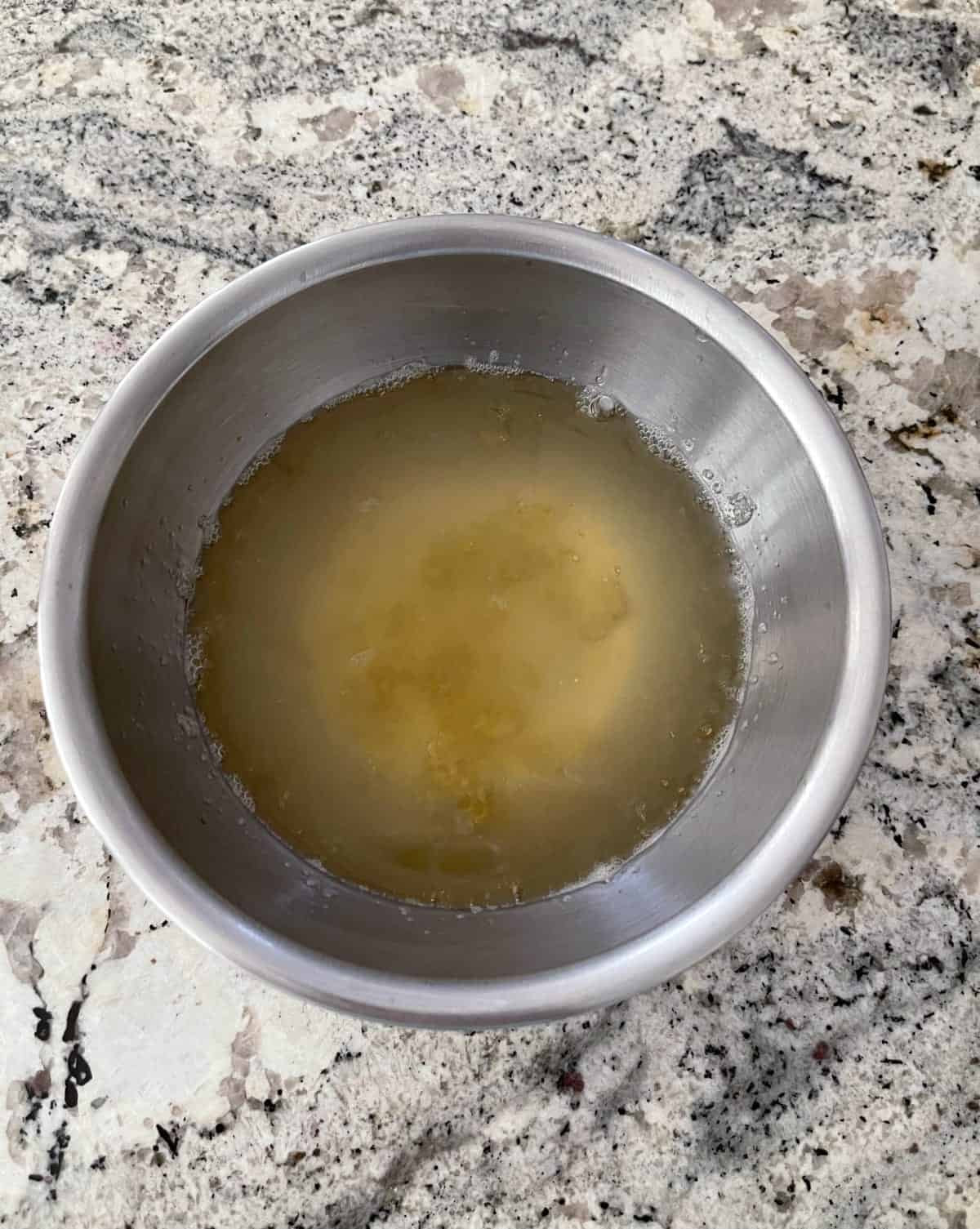 Softening unflavored gelatin in stainless mixing bowl.