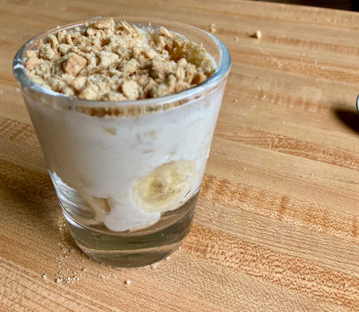 Homemade banana yogurt cup with crushed graham crackers