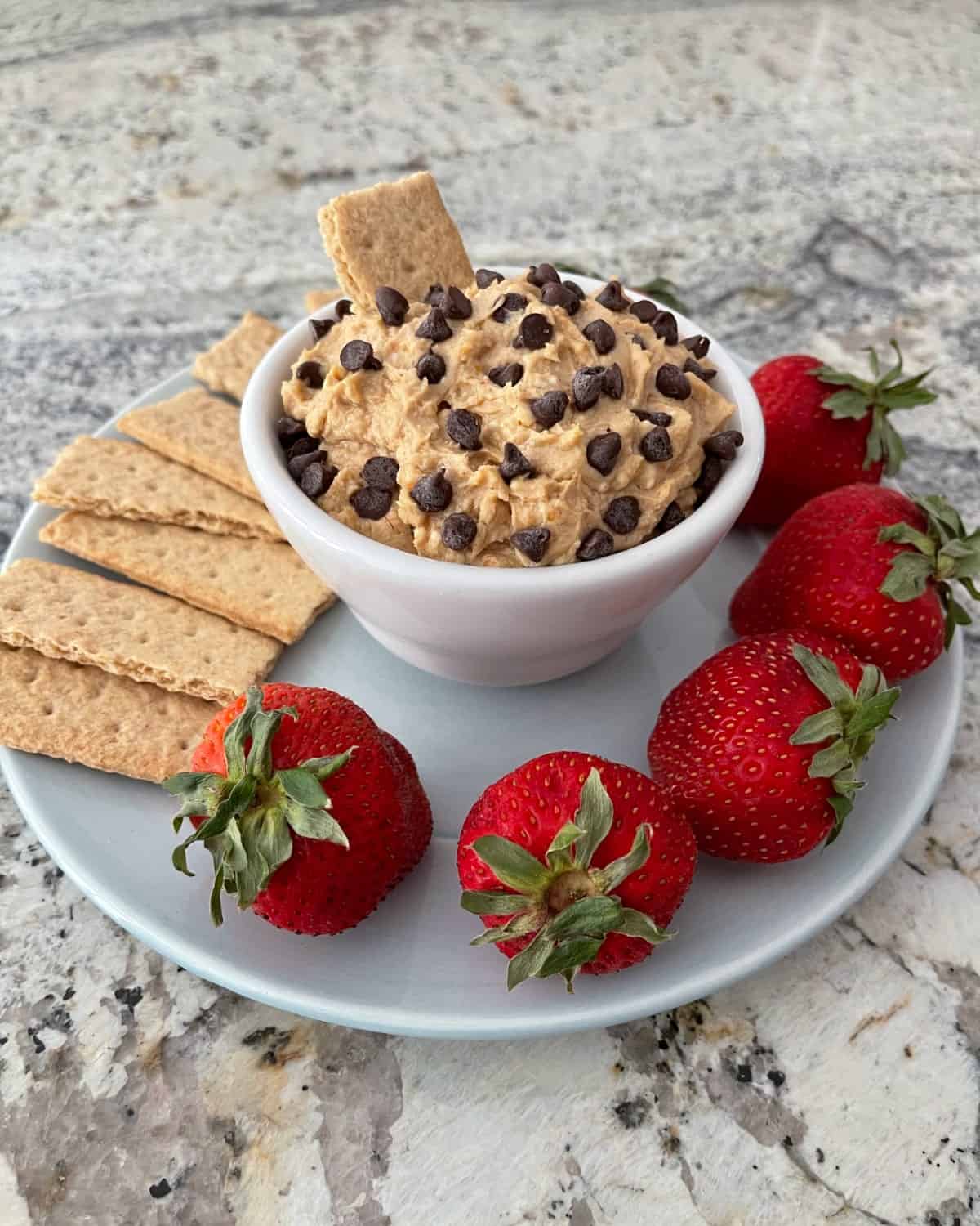 Peanut butter cup dip with graham crackers and strawberries.