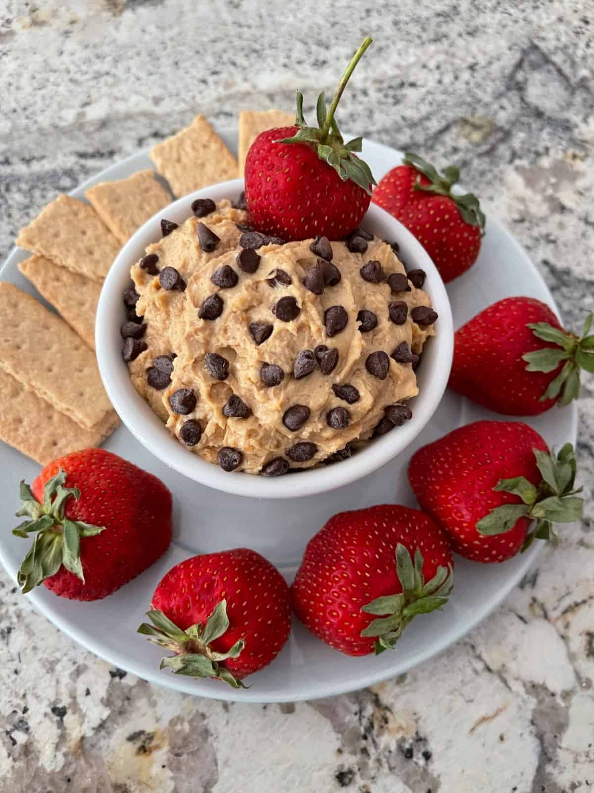 Peanut butter cup fruit dip with fresh strawberries and graham crackers.