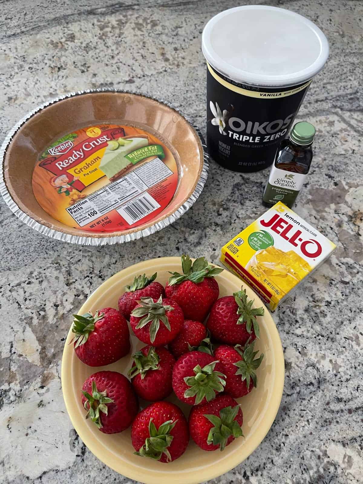 Ingredients including reduced-fat graham cracker crust, vanilla yogurt, mint extract, lemon Jello and strawberries