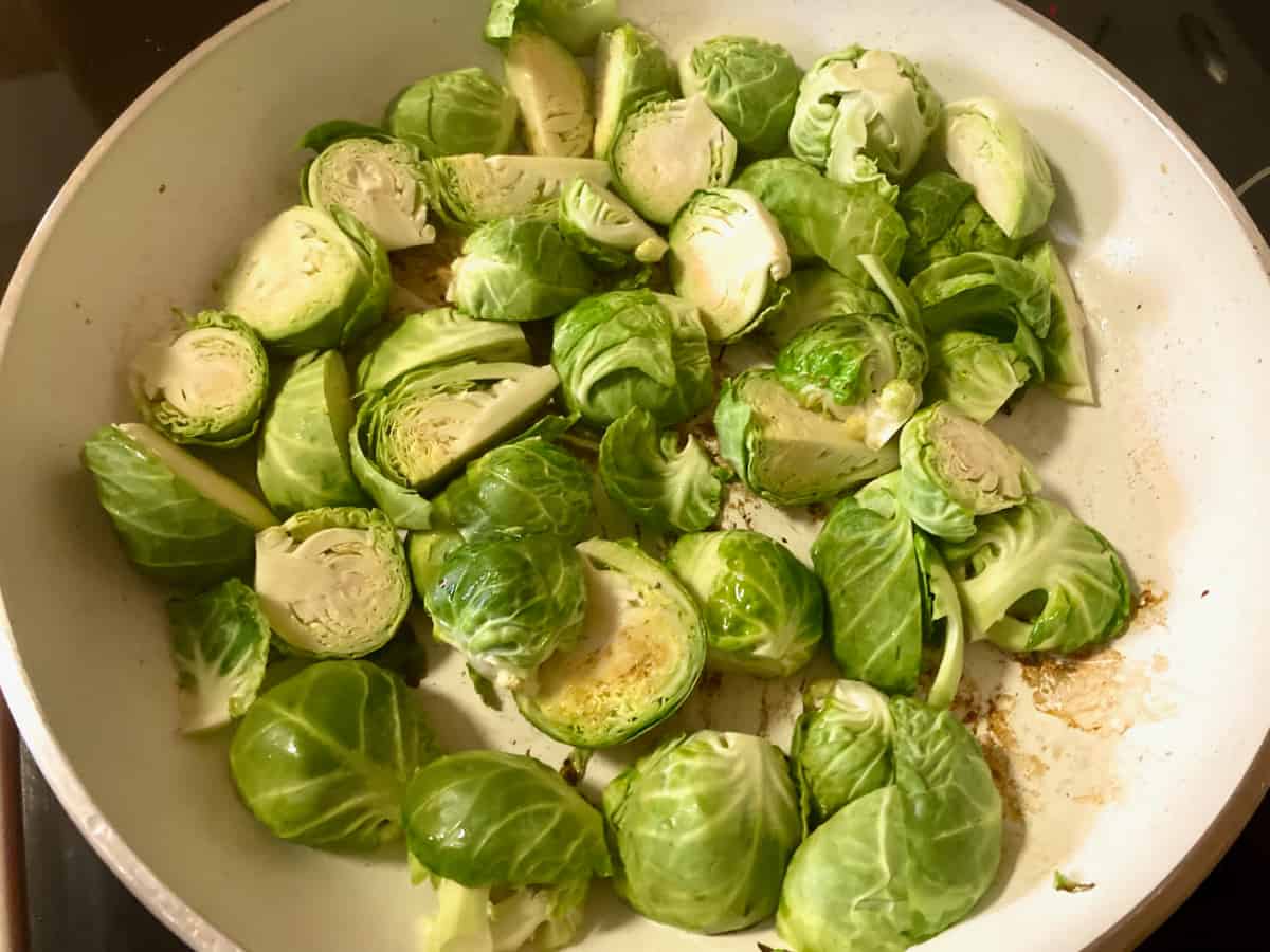 brussels sprouts cooking in a skillet