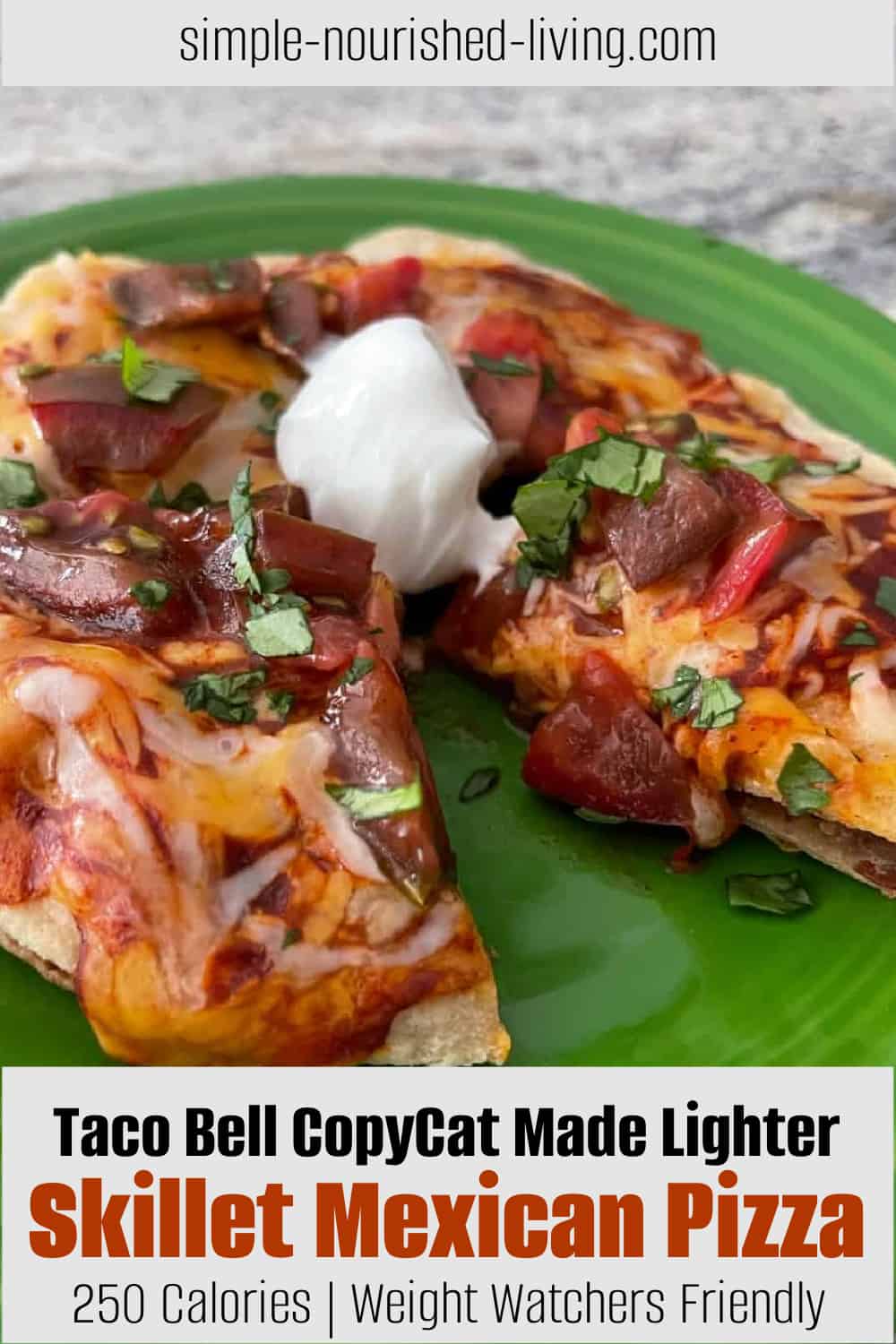 Skillet Mexican Pizza topped with lite sour cream on small green plate with slice removed.