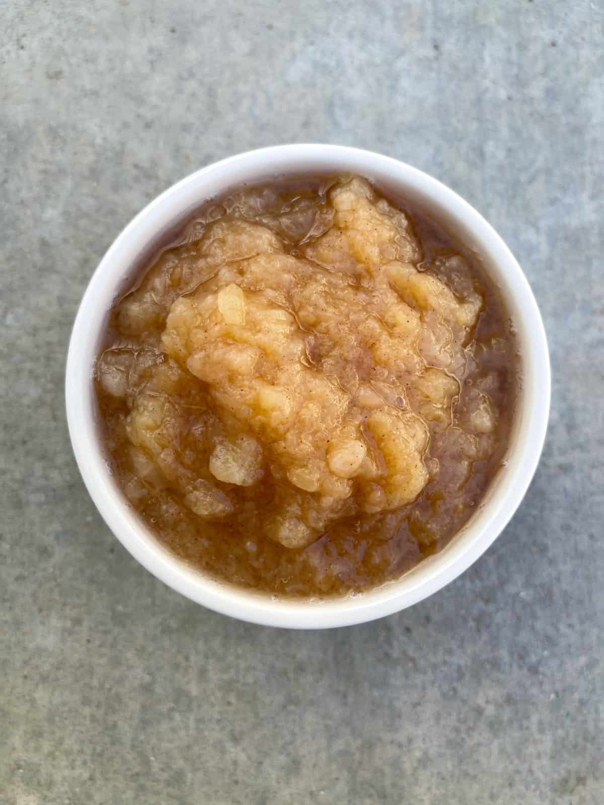 Instant Pot cinnamon applesauce in white bowl from above.