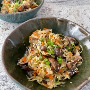 two pottery bowls filled with vegetarian egg roll in a bowl mixture