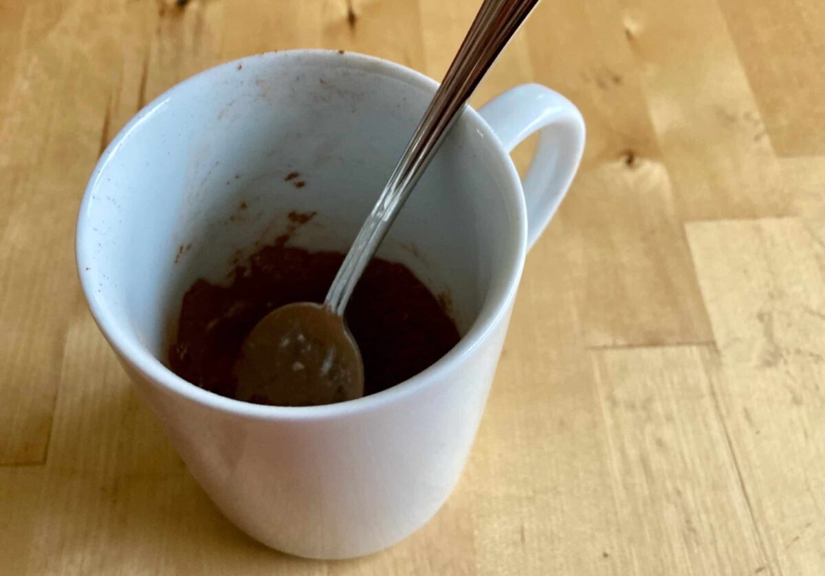 cocoa, truvia, cornstarch in a white mug with spoon