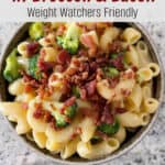 bowl of macaroni & cheese with broccoli topped with bacon with text for pinterest pin
