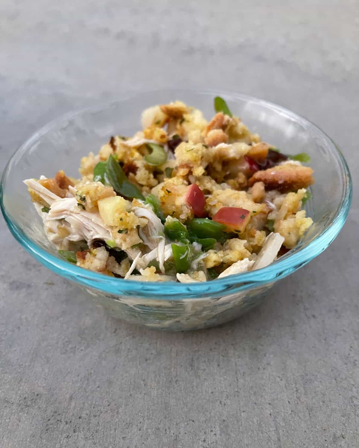 Single serving of chicken and apple stuffing casserole in glass bowl.