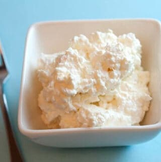 white square dish filled with cottage cheese on a blue counter