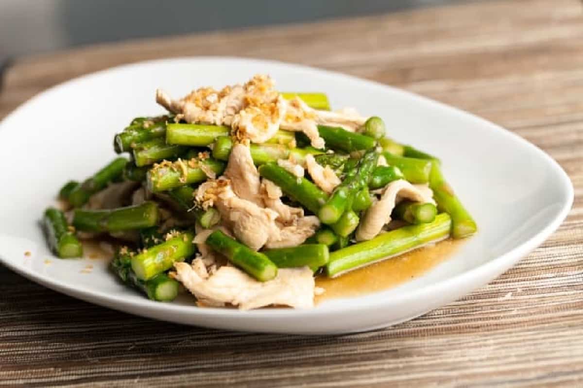chicken and asparagus stir fry on white plate