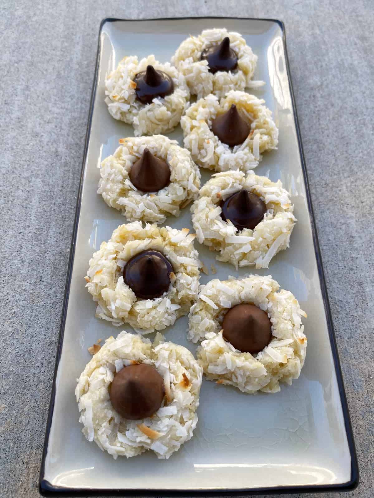 Coconut macaroon kiss cookies on rectangular platter.