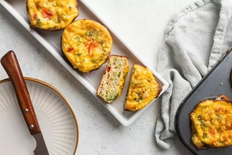 Cottage Cheese Omelet Muffins arranged diagonally on a long narrow white plate.