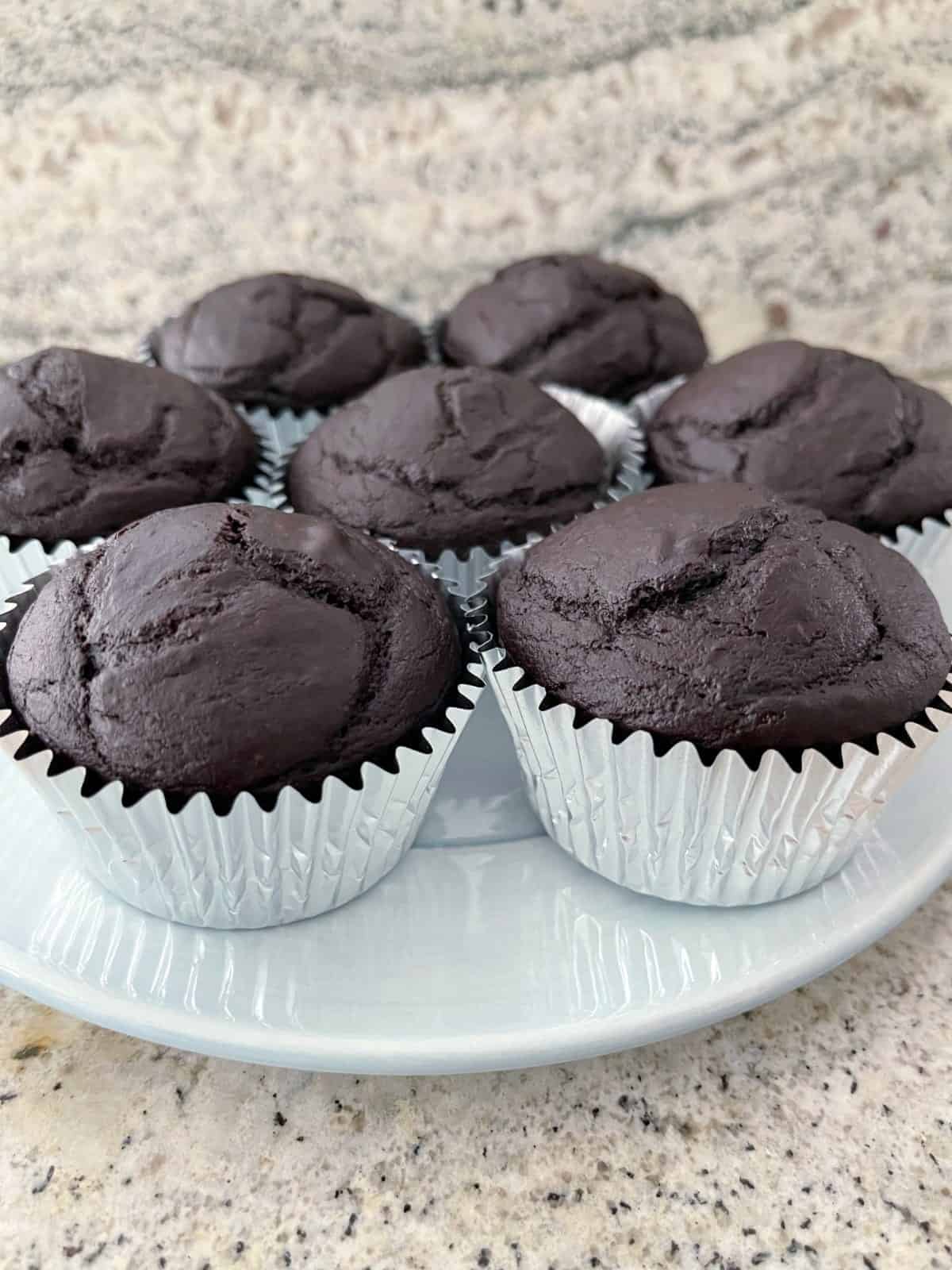 90-calorie chocolate cupcakes on small blue serving platter.