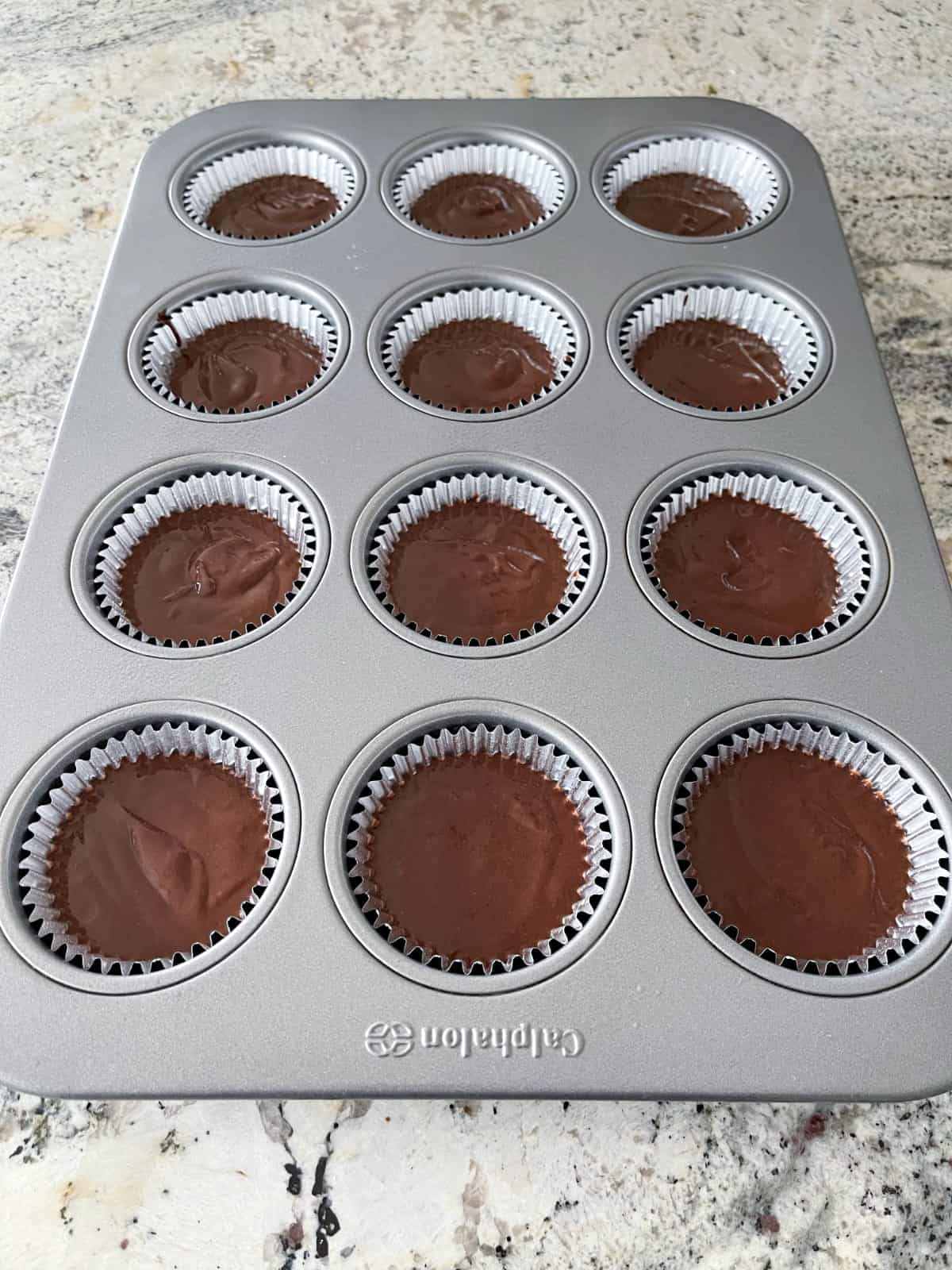 Unbaked chocolate cupcakes in muffin pan.