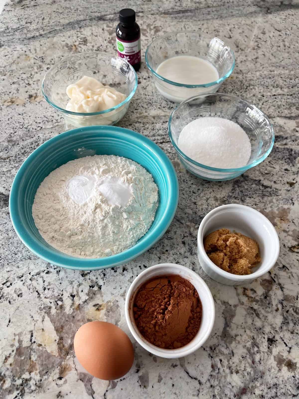 Ingredients including vanilla extract, light mayonnaise, 0 calorie sweetener, flour, brown sugar, cocoa and an egg.