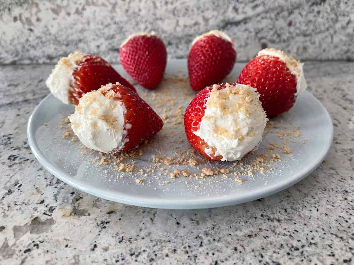 Cheesecake stuffed strawberries and sprinkled with graham cracker crumbs.