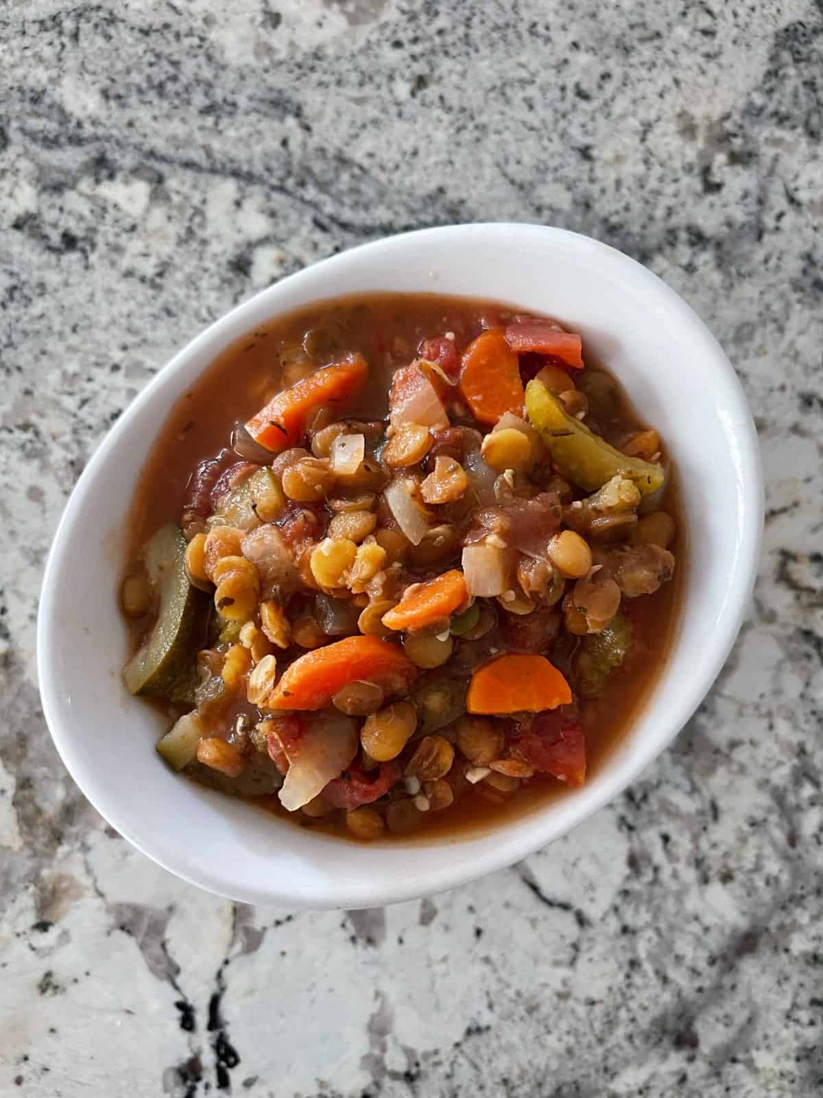 Instant Pot Vegetarian Minestrone with lentils in white bowl on granite.