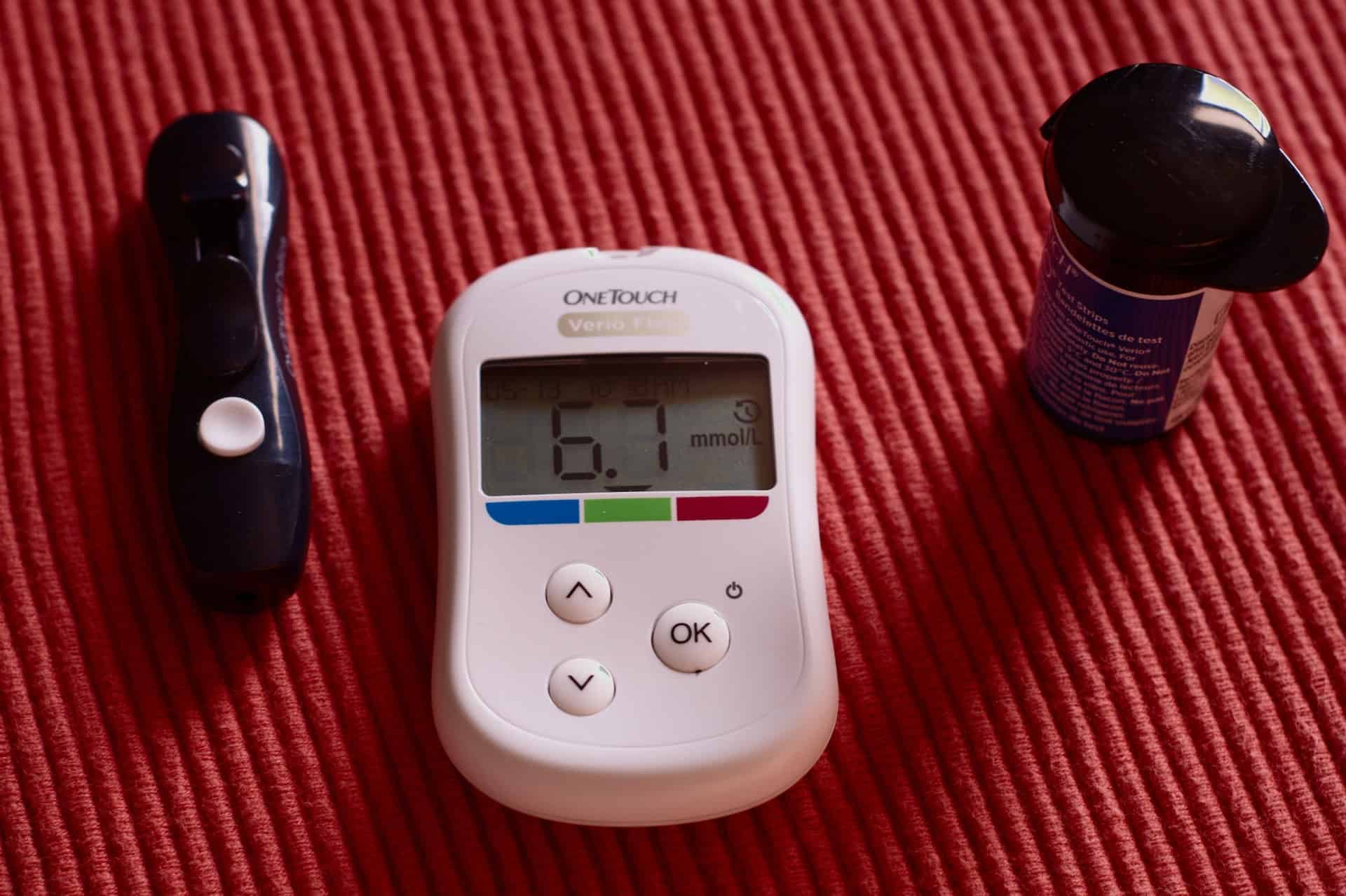glucose meter on red mat