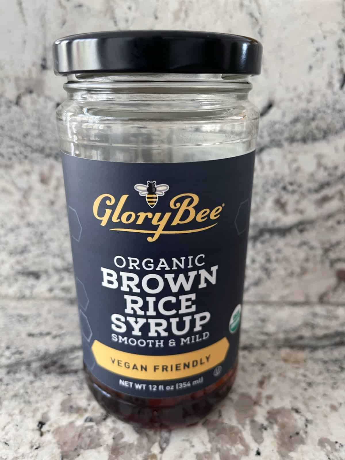 Jar of GloryBee Organic Brown Rice Syrup on granite.