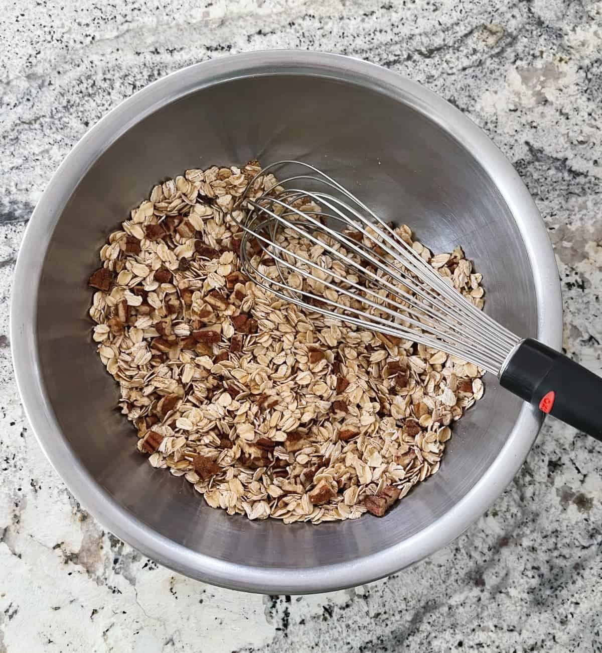 Rolled oats, chopped pecans, flax meal and ground cinnamon in mixing bowl with whisk.