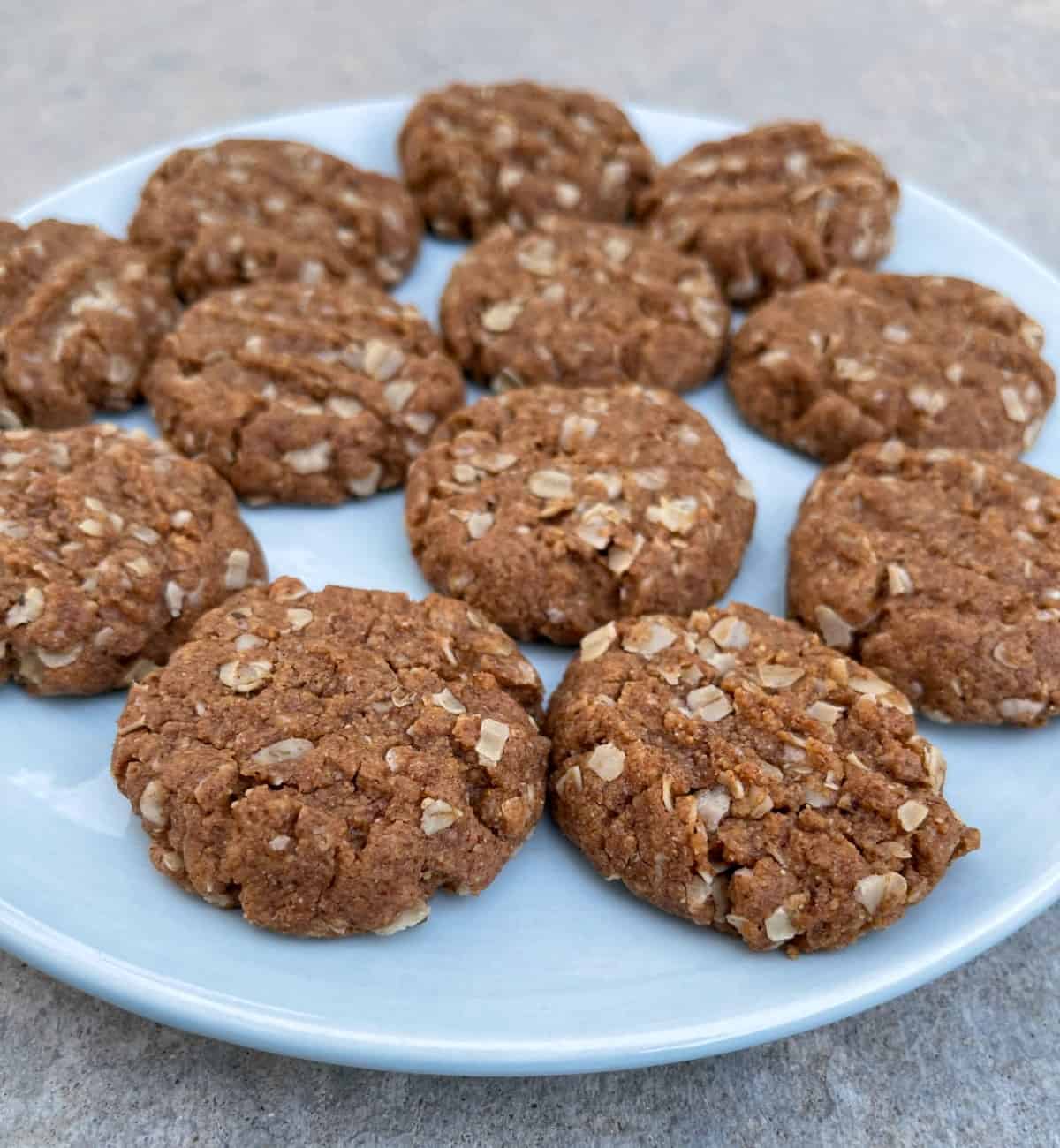 Soft and chewy almond butter cookies on blue serving plate.