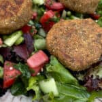 Close up of Mediterranean Green Salad topped with Tofu Falafel Patties
