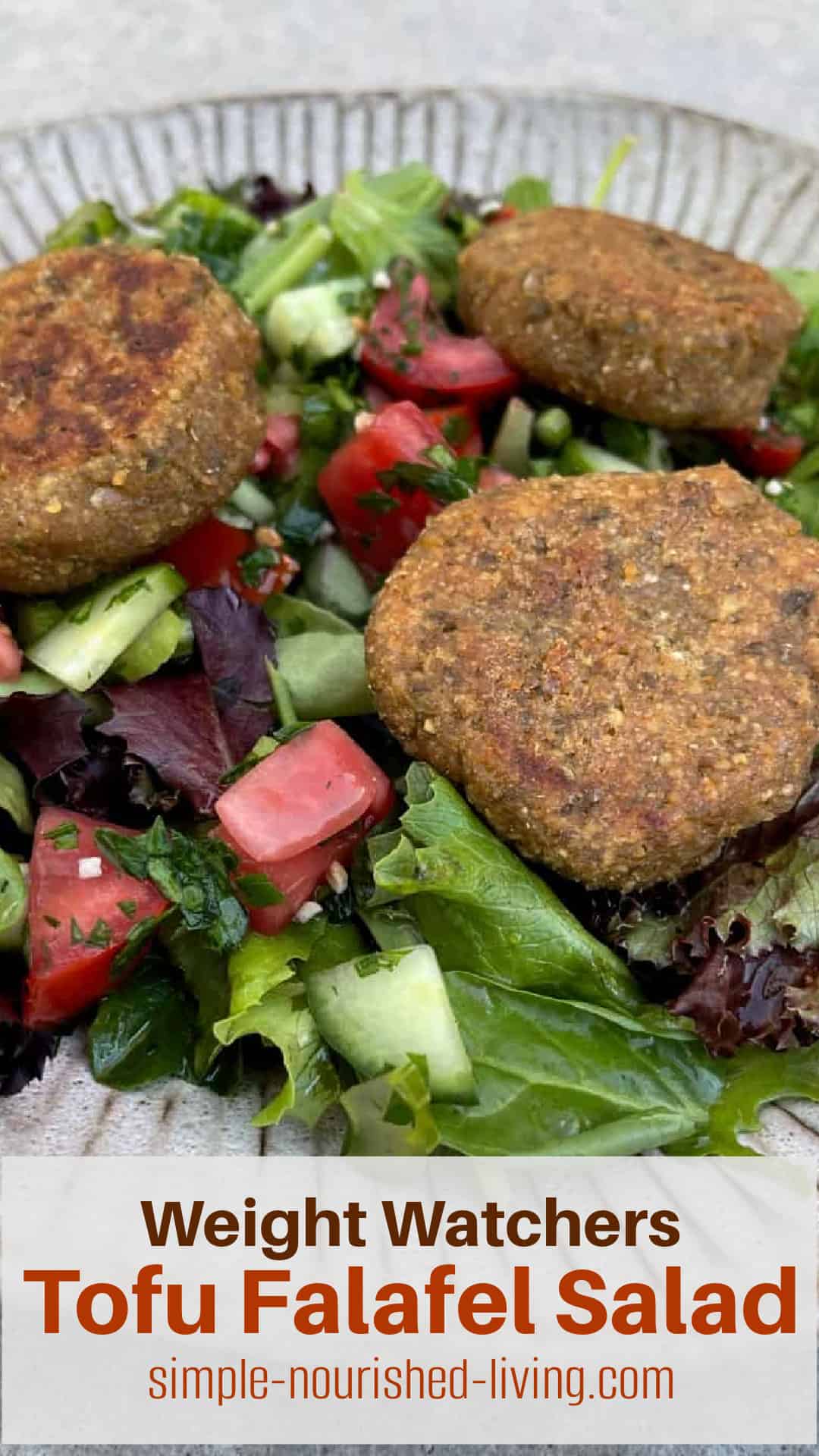 Close up of Mediterranean Green Salad topped with Tofu Falafel Patties.