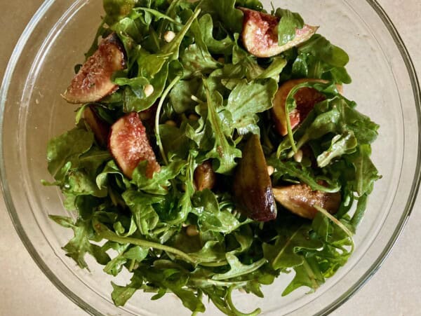 Fig Arugula Salad in large clear glass bowl shot from above