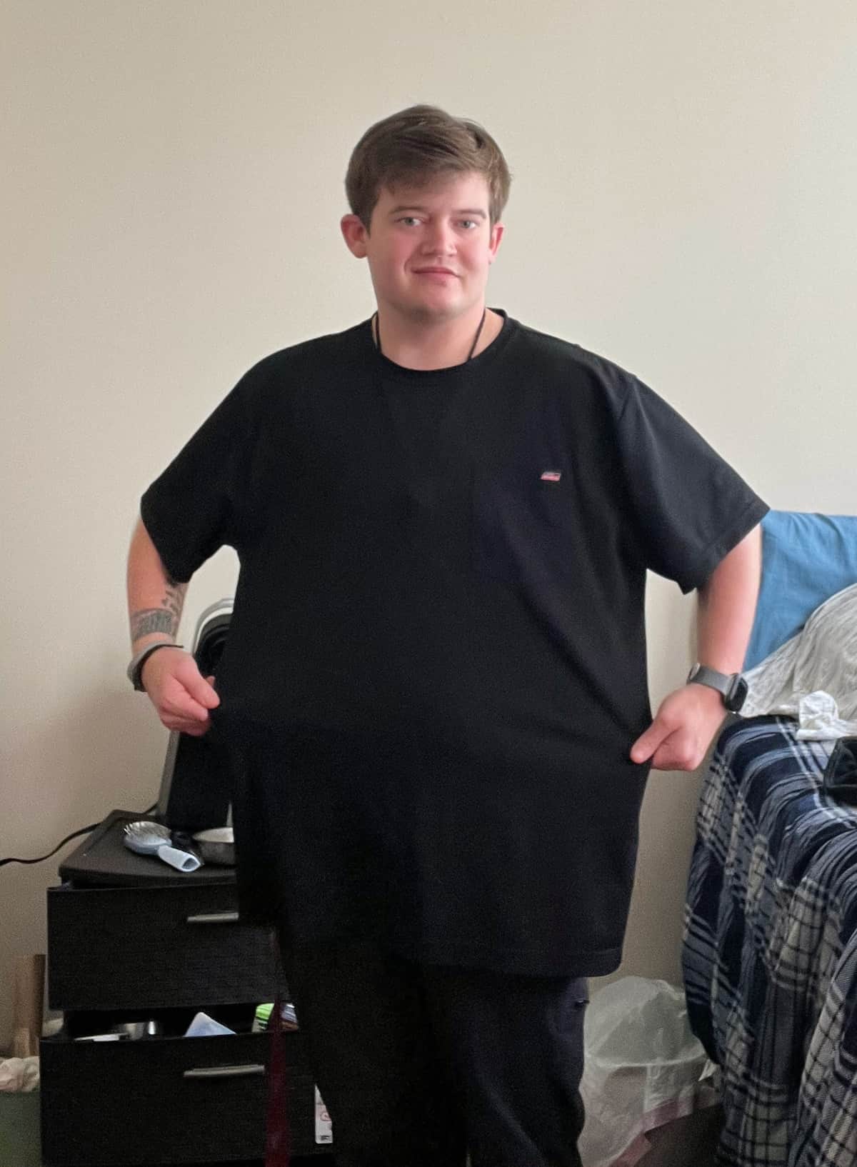 Matthew wearing XXL shirt and showing off his 67 pound weight loss.