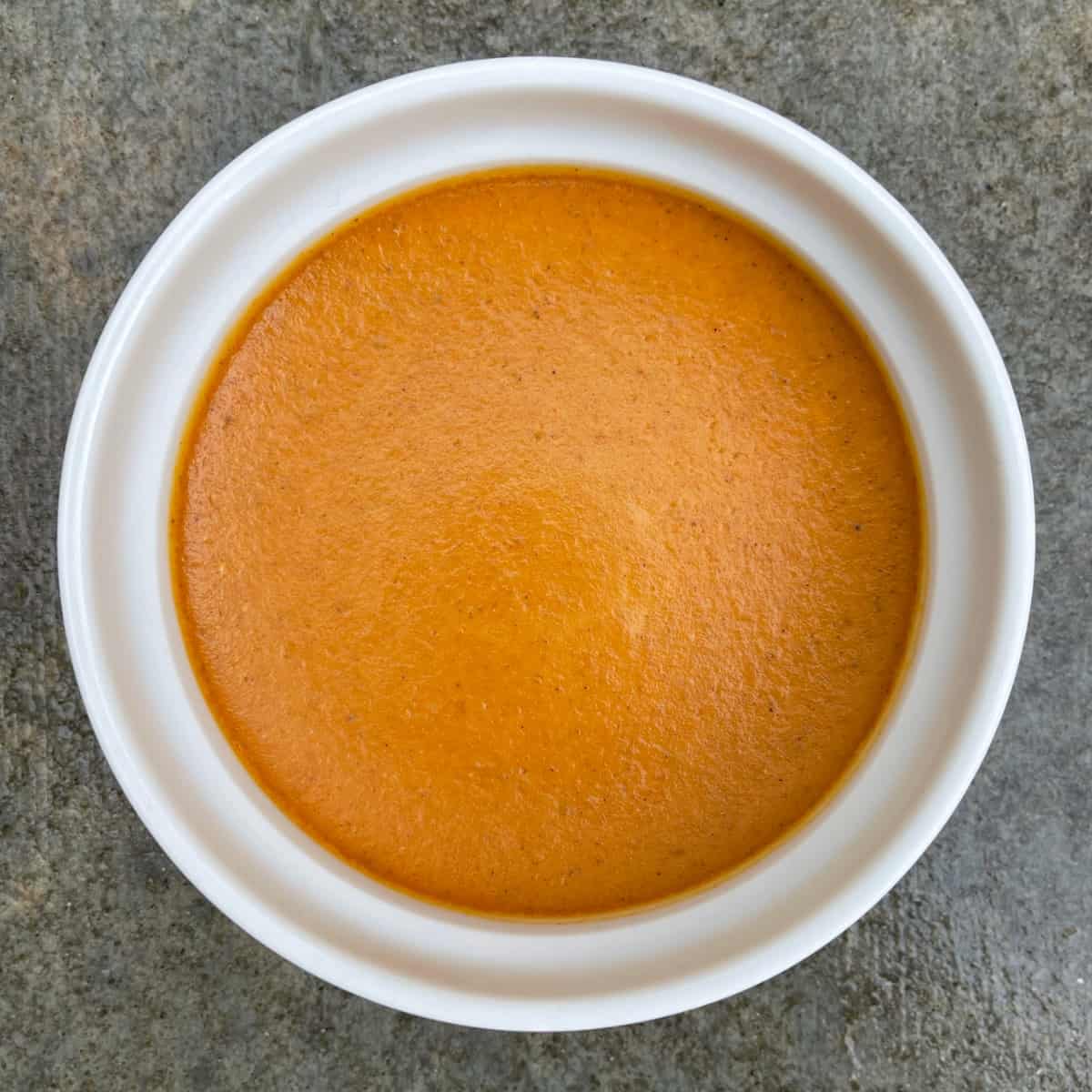 No crust pumpkin pie dessert cup in small white ramekin without topping.