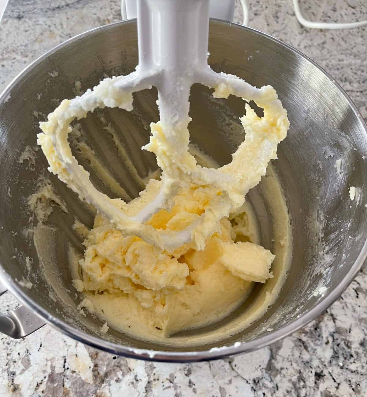 Beating butter, sugar, salt, eggs and rum extract in stand mixer with paddle attachment.