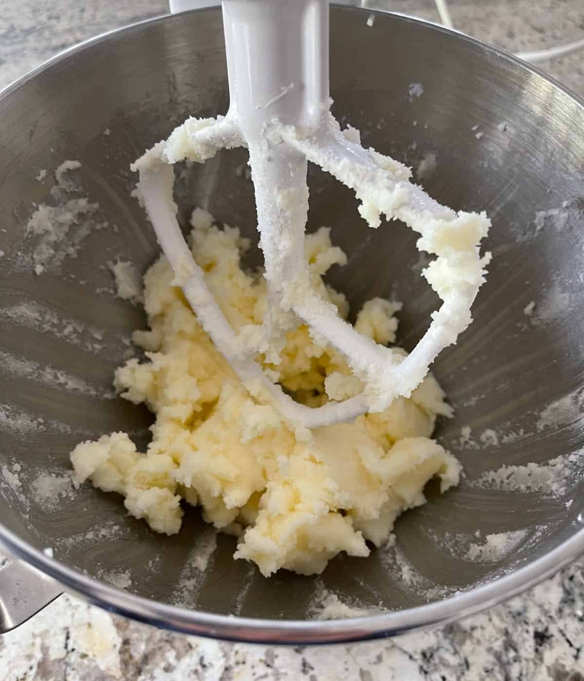 Creaming butter, sugar and salt in a stand mixer with paddle attachment.