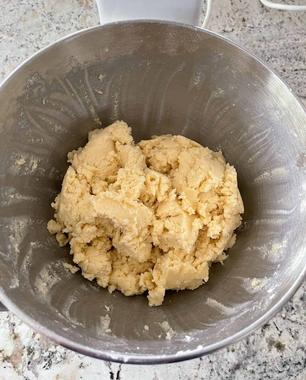 Eggnog snickerdoodle cookie dough resting in mixing bowl.