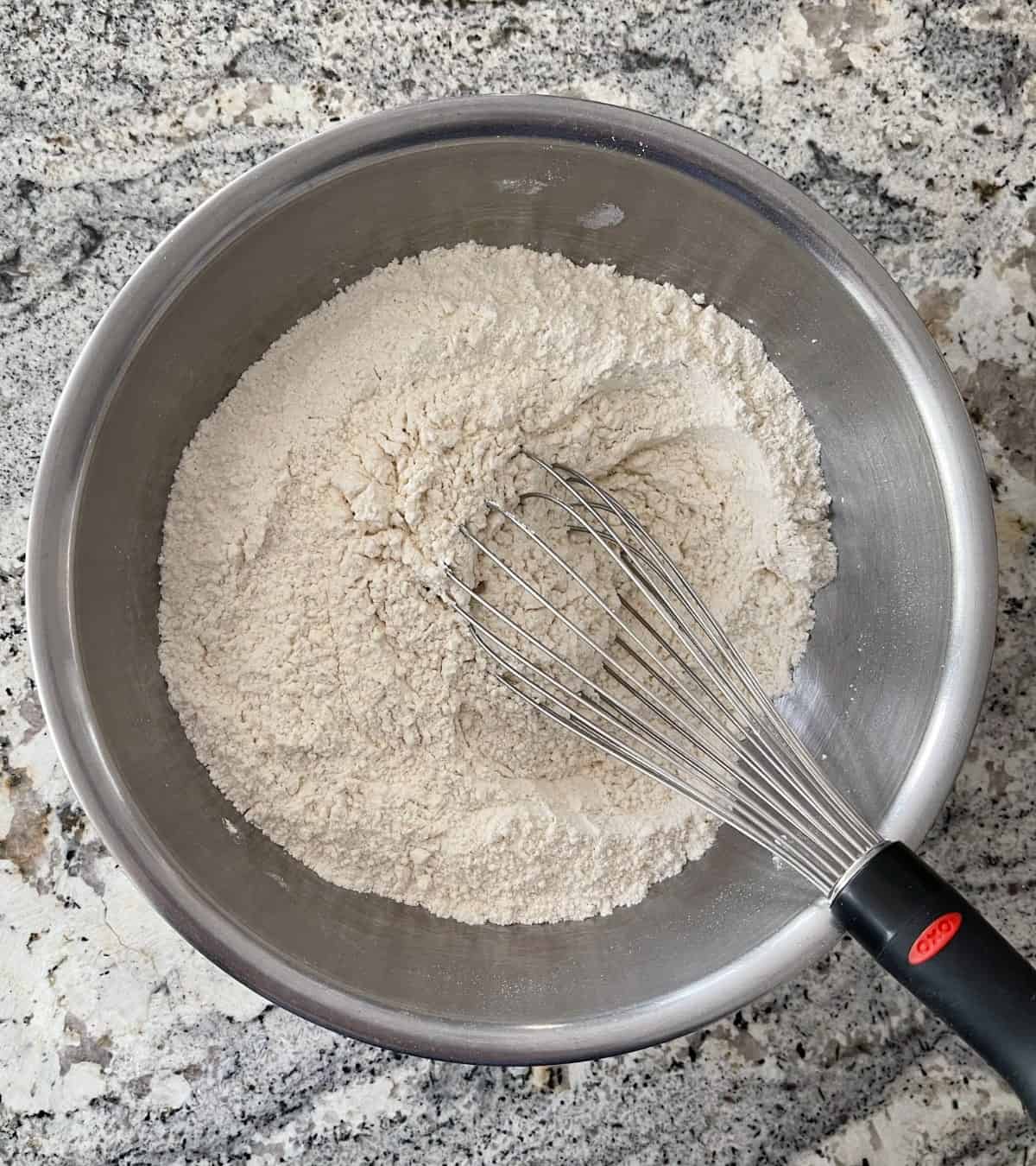 All-purpose flour, cream of tartar and baking soda in mixing bowl with whisk.