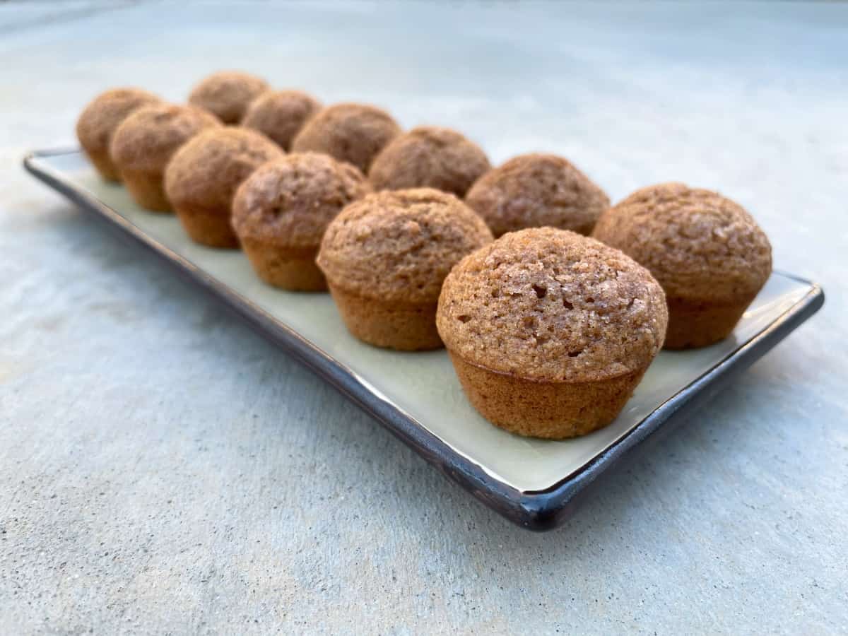 Cinnamon apple mini muffins on rectangular serving platter.