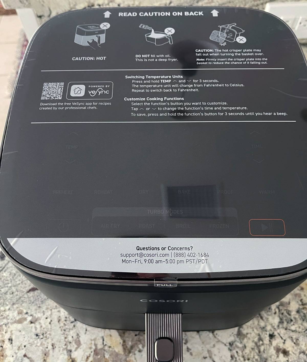 Cosori air fryer sticker with warnings and cautions for using the air fryer, along with a QR code for accessing an app with additional recipes, and information for contacting customer support.